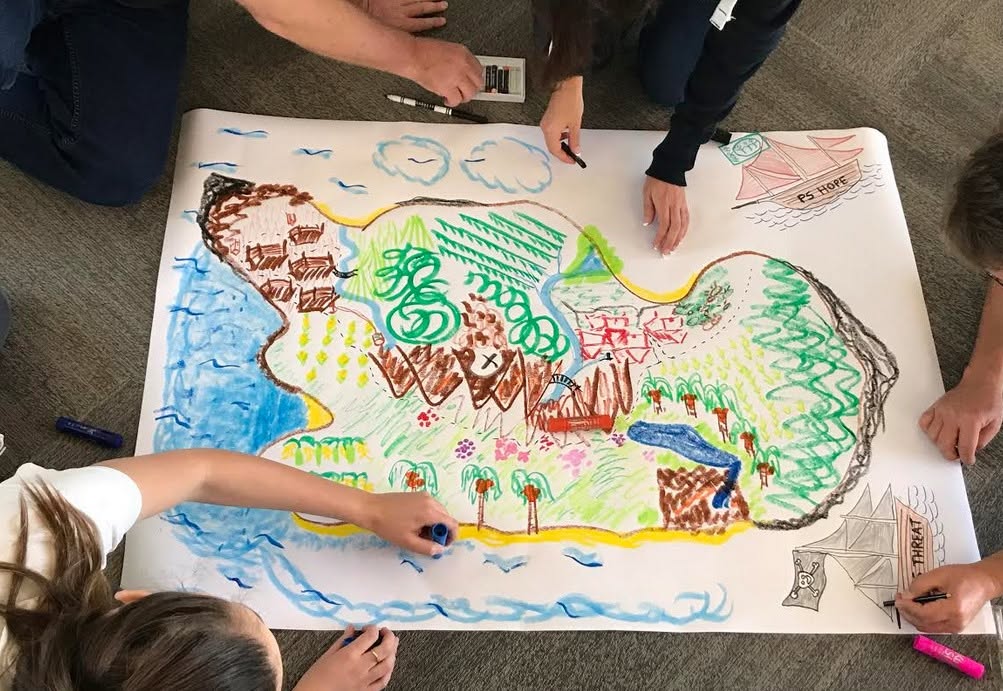 A small group making a colorful collaborative painting together during a group art session