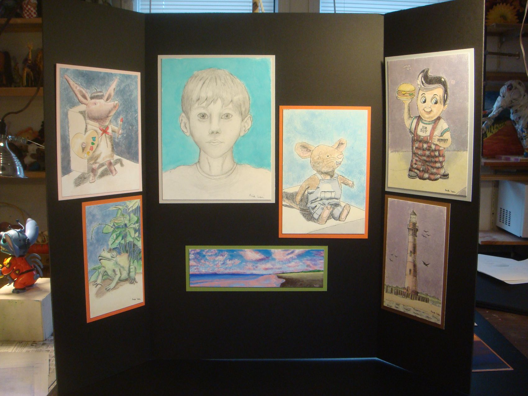 Accepted student's portfolio board with self-portrait and illustrations