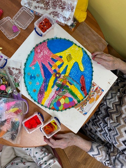 A colorful beaded mandala artwork made by hand during an art therapy session